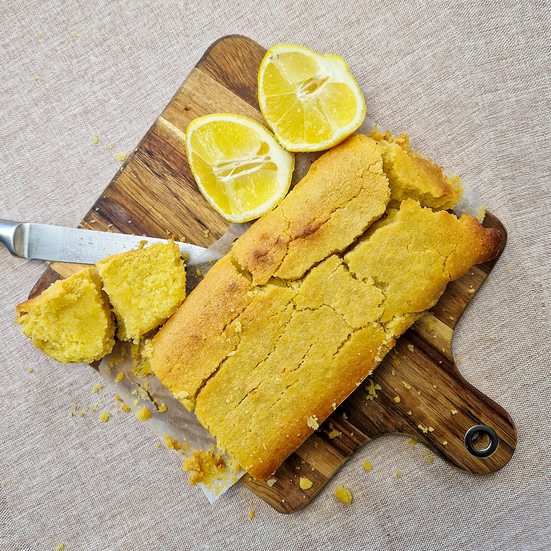 Lemon Polenta Cake on a wooden chopping board