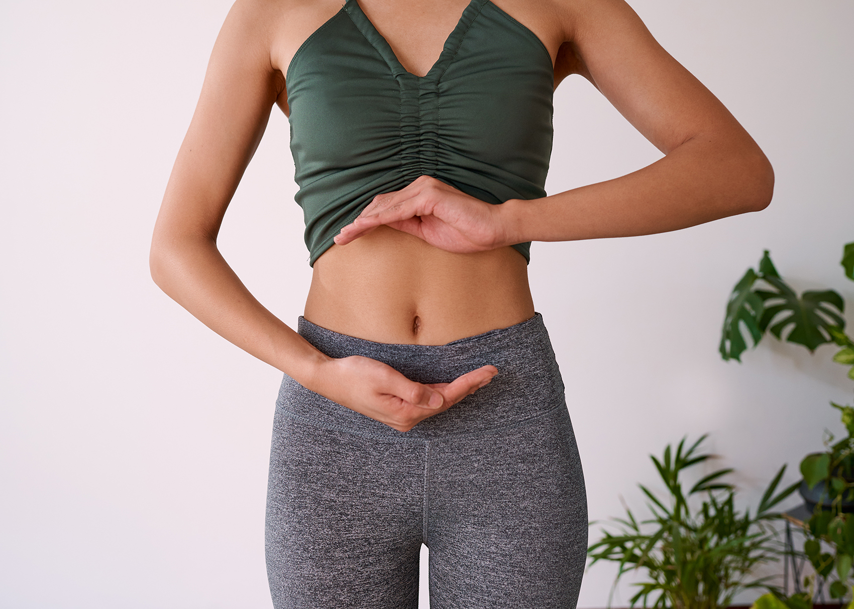 Woman posing using hand gestures to represent gut health